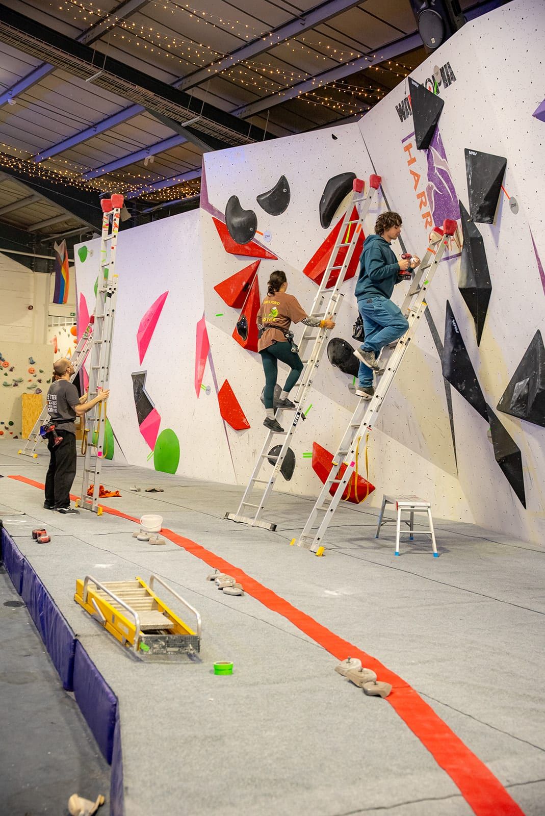 Setters on ladders working on a comp wall